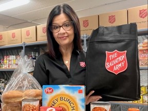 Salvation Army food bank co-ordinator Alice Wannan holds a tote bag like those given to homeless people filled with monthly food provisions. The ongoing Thanksgiving food drive particularly needs cereal, pasta, granola bars, boxed crackers, small peanut butter jars, packaged side-dishes, be they of rice, potato, pasta or stuffing. (Supplied to The Sun Times/Postmedia Network)