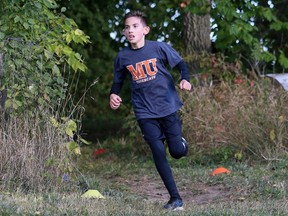Emerson Alves of Monsignor Uyen runs out of the woods en route to winning the Grade 6 boys' race at the Kent Catholic Schools Athletic Council cross-country meet at the Thames Grove Conservation Area in Chatham, Ont., on Thursday, Sept. 29, 2022. Mark Malone/Chatham Daily News/Postmedia Network