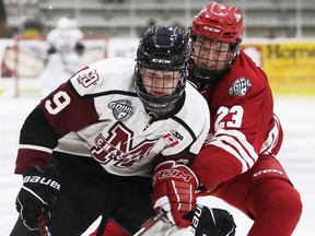 Chatham Maroons' David Brown (89) is checked by Leamington Flyers' Seth Martineau (23) at Chatham Memorial Arena in Chatham, Ont., on Saturday, Oct. 8, 2022. Mark Malone/Chatham Daily News/Postmedia Network
