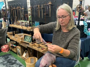 Karen Rivers was turning carded alpaca wool into yarn, using a drop spindle at the annual Woolstock Fleece Festival on Saturday at the Paris Fairgrounds.