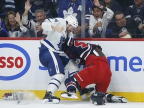 Winnipeg Jets' Josh Morrissey Toronto Maple Leafs' Morgan Rielly duke it out on Saturday night. The Jets lost the game 4-1. JOHN WOODS/THE CANADIAN PRESS