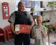 Officer Kurtis Taylor, GPES, left, and  Dalien Wiebe. Wiebe was the winner of the Positive Ticket Program for 2022 and took home a Nintendo Switch and game.