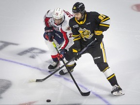 Windsor Spitfires’ Nicholas DeAngelis, left, and Sarnia Sting’s Marcus Limpar-Lantz, battle for the puck in OHL action at the WFCU Centre in Windsor, Ont., on Saturday, Oct. 1, 2022.   (DAX MELMER/Windsor Star)