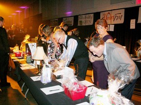 Big Night Out attendees look at silent auction items during a past gala. Sentinel-Review file photo