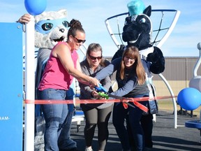 Leslie-Anne Petcoff (from left to right) Tracey Oldale, and Tracy Wasylucha cut the ribbon on W.G. Murdoch's new inclusive playground. The three ladies spearheaded the majority of the fundraising work to see the playground built as members of the Friends of W.G. Murdoch. Photo by Riley Cassidy/The Airdrie Echo/Postmedia Network