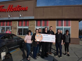 Tim Hortons staff and owners present Airdrie Health Foundation executive director Michelle Bates and volunteers with the money raised from this year's Smile Cookie Campaign. For the second year in a row local Tim Hortons broke their own fundraising record, raising close to $50,000 for the charity.