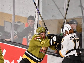 Brayden Turley of the visiting North Bay Battalion confronts former Battalion forward Owen Outwater of the Kingston Frontenacs in Ontario Hockey League action Friday night. The Troops won 3-2 via shootout.