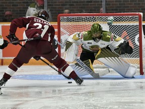Goaltender Dom DiVincentiis of the North Bay Battalion braces for a scoring attempt by Chase Stillman of the Peterborough Petes in the second period of the teams' Ontario Hockey League game Thursday night. The Troops won their home opener 3-1.