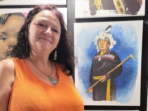Native Renaissance owner Gudgie Maracle-Doreen poses with a painting of her late grandfather, one of 139 painted by Deseronto artist Kenny Leighton as part of his Truth and Reconciliation Project exhibition, on display at the gallery until the end of the month. (Jan Murphy/Local Journalism Initiative)