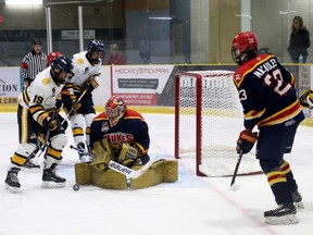 Wellington Dukes goalie Jacob Osborne is surrounded by Burlington Cougars as he makes a second-period save Sunday afternoon at Lehigh Arena. The Cougars stormed back from a 3-1 deficit to grab a 5-4 win. BRUCE BELL