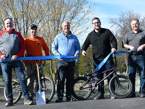 Belleville Mayor Mitch Panciuk and Councillor Tyler Allsopp performed the official ribbon-cutting ceremony at BMX Pump Track along with Rowland Cave-Browne-Cave, Manager, Operations Planning and Development, and Joe Reid, General Manager Transportation and Operational Services Friday at West Riverside Park. MARILYN WARREN PHOTO