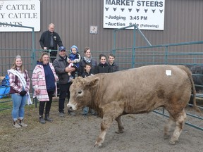 The Grand Champion Steer at the 2022 Norwood Fair was raised by Doug Leahy (pictured with his family). The impressive animal was purchased by Kroes Croquettes represented by Annemarieke Kroes (second from left). The 2022 Fair Ambassador Emma Harding was on hand to present the winner's trophy; also in the picture is Auctioneer Mark Stanley. SUBMITTED PHOTO