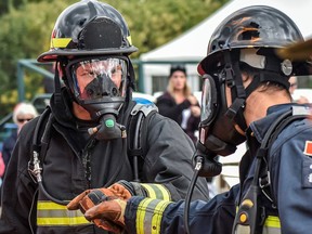 Quinte West FireFit team members Greg King and Pat Millington bump fists during the 2022 World Firefighter Combat Challenge held in Sandy, Utah, earlier this month. SUBMITTED PHOTO