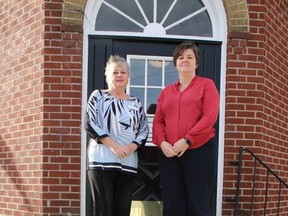 Marmora Librarian Kathy Farrell and Ontario Library Services CEO Mellissa D'Onofrio pose on the main steps of the Marmora & Lake Public Library behind a sign promoting the new high speed internet and wifi service. JACK EVANS PHOTO