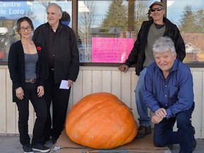 Pictured here, gathered around the 480 lb pumpkin that was the centerpiece of a 50/50 guess-the-weight-of-the-pumpkin contest that raised $400 for the Stirling Food Bank, are Julie Yoo of the Pro One Stop and Don McCrory of the Food Bank. Kneeling on the right is Mike Kerby, whose Kerby Hollow Farms supplied the giant pumpkin, while smiling and standing in back is contest winner, Dan Fletcher, of Stirling. Just before this photo was snapped, Dan announced he had generously handed his winnings over to the Food Bank. TERRY VOLLUM PHOTO