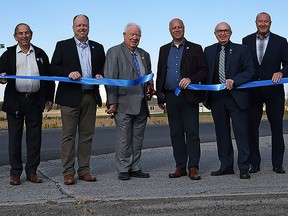 Pictured, left to right: Asphalt General Manager for Drain Bros. Excavating Limited Brian Shorey, City of Belleville CAO Rod Bovay, City of Belleville Councillor Garnet Thompson, Councillor Paul Carr, Quinte West Mayor Jim Harrison, Belleville Mayor Mitch Panciuk, Councillor Bill Sandison, Councillor Sean Kelly, Belleville General Manager of Transportation & Operations Services Joe Reid, and Quinte West Director of Public Works & Environmental Services Chris Angelo. MARILYN WARREN PHOTO