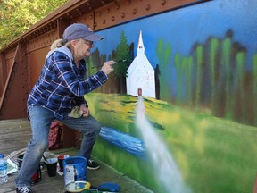 Brantford artist Cathy Grieve spent Tuesday re-creating one of her previous paintings of the Mohawk Chapel on a bridge panel as part of the TH&B Pedestrian Crossing Bridge public art project. Michelle Ruby