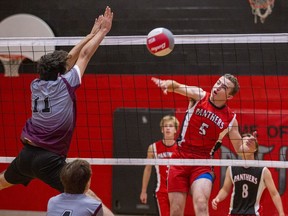 Thomas Kitchen of the Paris District High School Panthers watches his spike sail past a block attempt by Yusuf Aburkhes of the Pauline Johnson Thunderbirds during a high school senior boys volleyball match on Thursday in Paris. Brian Thompson/Brantford Expositor/Postmedia Network