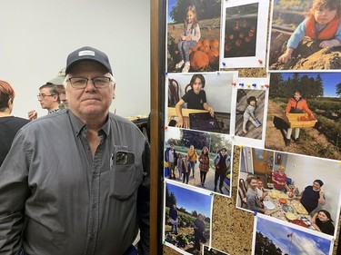 Mike Kloepfer, of Titan Trailers, stands next to a collage of photos of some of the Ukrainians who have moved into Schafer House, the former federally-operated Delhi Research Station, which has been refurbished into apartments for Ukrainian families that have fled their war-torn homeland. Vincent Ball