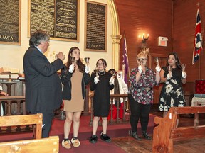 Barry Hill (left), warden of Her Majesty's Royal Chapel of the Mohawks in Brantford watches as (left to right) Keyshia Van Every, 13, of Paris and her eleven-year-old sister Maya; Denise Shiell of Oxford Centre; and Melanie Hill of Hamilton ring silver hand bells during a Royal Commemoration Thanksgiving Service  on Sunday.