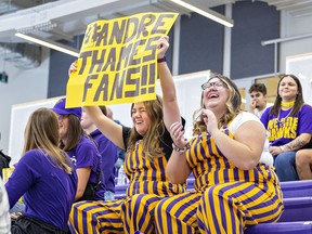 Sarah Danielson (left) and Katie McPhee, both 2020 graduates of the social work program at Laurier Brantford cheer during a basketball game at the Laurier Brantford YMCA during Homecoming 2022 on Saturday.