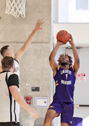 Devayne Afriyie of the men's extramural team goes up with a shot during a basketball game against Golden Hawk Alumni players.