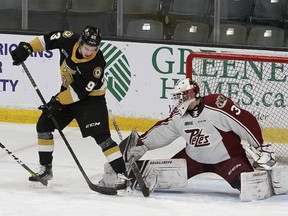 Kingston Frontenacs forward Maddox Callens of Norfolk County tries to deflect the puck past Peterborough Petes goalie Ty Austin during Ontario Hockey League action at the Leon's Centre in Kingston last season. Callens has just been cleared to resume contact practices after undergoing shoulder surgery last spring. Postmedia