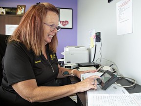 Lorraine Pderesen, vice-president of Alpha Micro Tech Inc. tests one of the firm’s units before shipping it out.