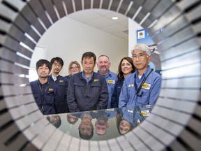 Mitsui High-Tec (Canada) Inc senior management (from left) Kohei Oku, business planning manager; Yoshihiro Maehara, sales project manager; Raquel Vandermeulen, finance manager; Seidou Kimura, plant manager; Kurt Palmer, operations manager; Leanne Corbett, HR manager; and Yasushi Harada, president are framed by a motor core the company manufactures at its Brantford facility.