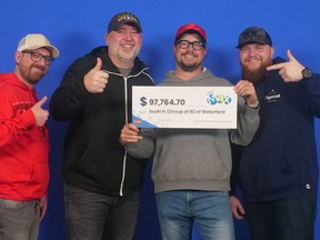 Scott Harris (red hat) of Waterford is one of 16  co-workers celebrating a $97,764 Lotto Max win. Submitted