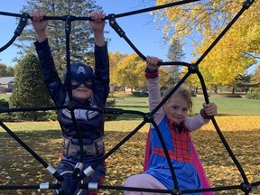 Austin Samuel, 6, dressed up as Captain America, and his four-year-old sister, Payton, dressed up as Spider-Girl, try the new equipment at the official opening of the Preston Park playground on Saturday. Vincent Ball