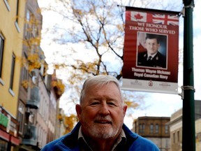 Navy veteran Wayne McIsaac poses by the banner honouring hias service on King Street West on Tuesday afternoon. (RONALD ZAJAC/The Recorder and Times)