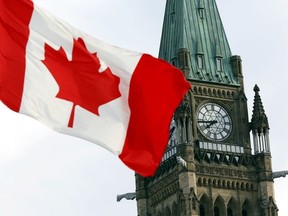 The Canadian flag flies on Parliament Hill in Ottawa.