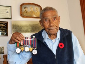John Olbey died on Monday at age 100. He is seen here at age, 98, displaying the several medals he earned while serving as a Sergeant in the 4th Canadian Armoured Division/Headquarters during the Second World War. He is shown on the left in the photo behind him with his brothers George, in the middle, who served in the Signal Corps, and Wilfred, who served in the forestry unit in British Columbia. Olbey is also in the group photo of the Fourth Canadian Armoured Brigade take in June 1944 in Marsfield, England. (Ellwood Shreve/Chatham Daily News)