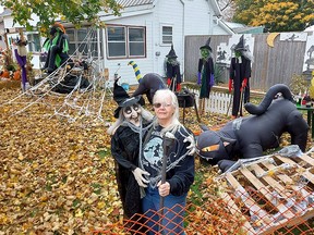 Sunni Shular has had vandals destroy some of the Halloween decorations in the front yard of her Dresden home for the last three years. Here, she holds an electronic witch that was one of the items damaged with vandals struck just after 12:30 a.m. Sunday, which she caught on her home security video system. PHOTO Ellwood Shreve/Chatham Daily News