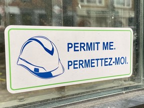A Permit Me sticker, part of a movement among "concerned and committed small business owners/developers in the City of Cornwall" seen in a storefront wintow on Thursday October 20, 2022 in Cornwall, Ont. Shawna O'Neill/Cornwall Standard-Freeholder/Postmedia Network