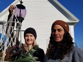 Left, Kim Weir holds up a hanging basket creation from Bush Babes co-owner Hanna Mullin, who is sporting one of Weir's toques, during the Lost Villages Musuem's Artisans in the Park, on Sunday October 9, 2022 in Long Sault, Ont. Greg Peerenboom/Special to the Cornwall Standard-Freeholder/Postmedia Network