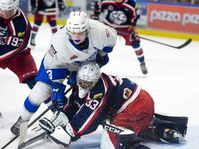 Navan Grads Gabriel Crete gets tied up with Cornwall Colts goaltender Dax Easter on Thursday October 13, 2022 in Cornwall, Ont. Cornwall lost 5-3. Robert Lefebvre/Special to the Cornwall Standard-Freeholder/Postmedia Network