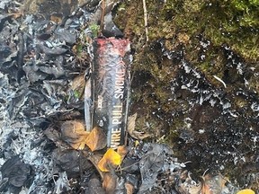 A smoke bomb left near an abandoned campfire off Tower Road. Regional Emergency Services responded to this fire on Oct. 19. Supplied Image/RMWB
