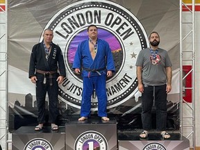 Dan Barsky (centre) with his gold medal. Barsky had not competed in eight years and defeated two brown belts to win his gold medal.