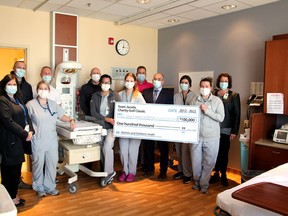 Team Jacobs poses with hospital staff and symbolic cheque.