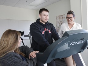 Graduate students Erin Miller, left, and Carlos Abrego, with project co-ordinator Bernadette Garrah in the Lifestyle and Cardiometabolic Research Unit at Queen's University on Monday.