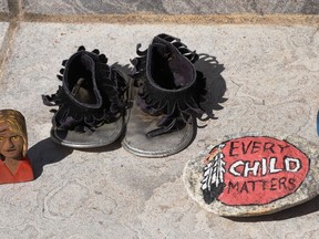 Dozens of pairs of little shoes filled the steps of Gananoque’s Town Hall as a memorial to those First Nations children who died in the residential schools. Placed among them were other symbols of remembrance Ð dream catchers, braided sweetgrass, cedar, tobacco, sage, painted stones and other totems. The memorial remained in place from the start of the First PeoplesÕ Performing arts Festival through September 30, the National Day for Truth and Reconciliation. Lorraine Payette/for Postmedia Network