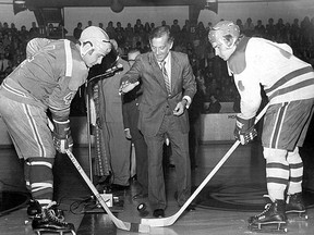 Former Kingston Mayor George Speal drops the puck between Kingston Canadians captain Gord Buynak, right, and Oshawa Generals captain Lee Fogolin prior to the Kingston franchise's first game in the Ontario Hockey Association Major Junior A Hockey League at the Kingston Memorial Centre on Friday, Sept. 28, 1973.