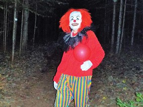 Photo by LESLIE KNIBBS
A scary clown wanders menacingly along the Haunted Trail.