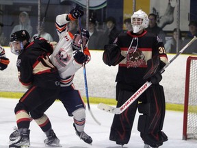 Soo Thunderbirds forward Dharan Cap (middle) and Blind River Beavers defenceman Adam Ferreira (left) battle for position in front of Beavers goaltender Charlie Burns during second-period NOJHL action at the John Rhodes Commnity Arena on Wednesday night. The Thunderbirds extended their win streak to four games with a 2-1 shootout victory.
