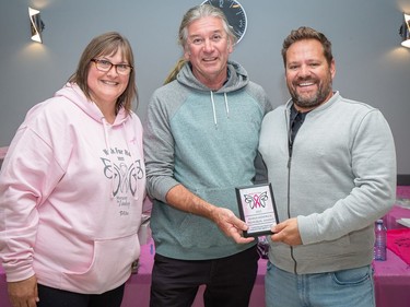 Raymond LaHay, right, is presented the Maria Kendrick Memorial Award following the 2022 Walk For Her event by Lana Gorr, left, creator and organizer of the fundraiser and Brian Kendrick, Maria's husband. Photo by John Butler