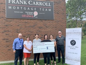Long-time supporter of the Pembroke Regional Hospital, Frank Carroll Financial, has made a $10,000 donation as a gift of humanity sponsor to this year's Pembroke Regional Hospital Foundation's Black and White Gala. Accepting the donation from Frank Carroll Financial represented by its staff members is Roger Martin, Foundation executive director.