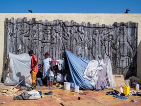 People displaced by gang war violence in Cite Soleil take refuge at the Hugo Chavez Square transformed into a shelter living in inhumane conditions in Port-au-Prince, Haiti, on Oct. 16.