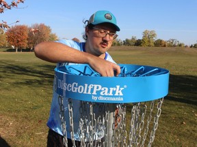 Patrick McCauley, with Peace Bridge Disc Golf, installs a basket Saturday on a disc golf course in Sarnia's Centennial Park. The nine-hole, par-three course was approved by city council earlier this year.